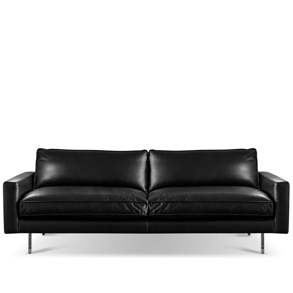 Minimalist genuine leather 3 seater sofa unique in white background.
