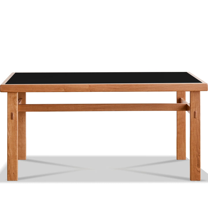 Wooden table with a black top on a white background