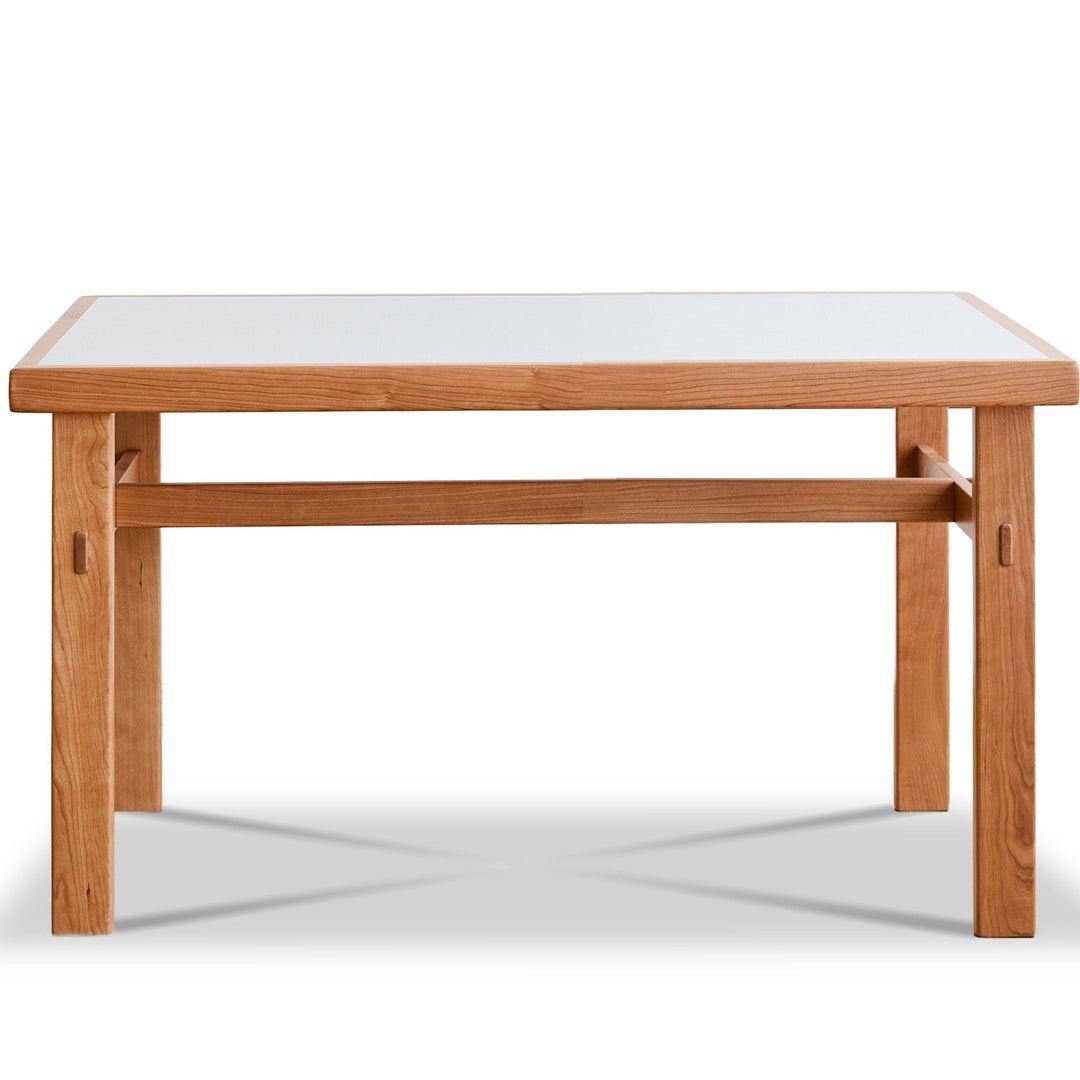 Wooden table with a white glass top on a white background