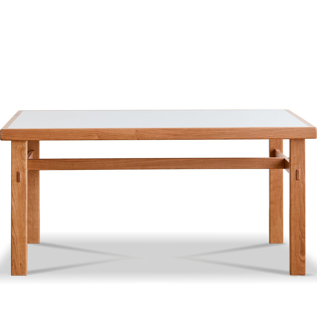 Wooden dining table with a white glass top on a white background