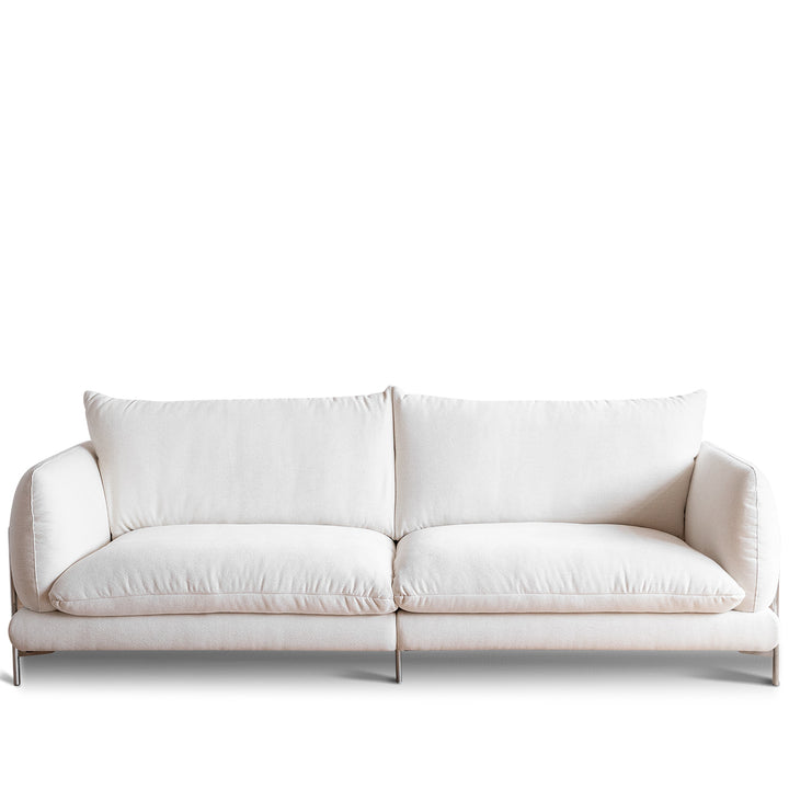 Minimalist cotton fabric 3 seater sofa como in white background.