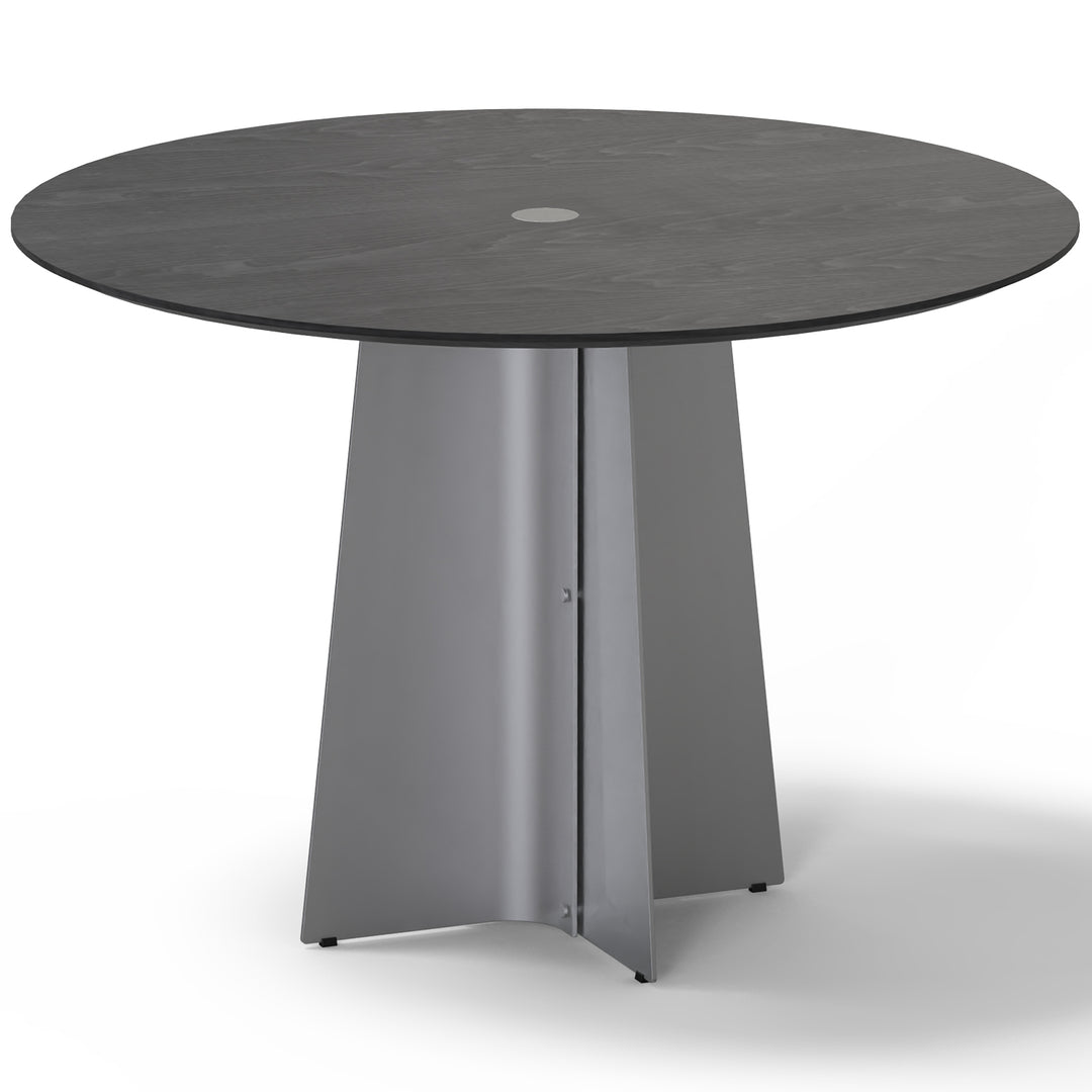 Minimalist ash wood veneer stainless steel round dining table black aeri in white background.