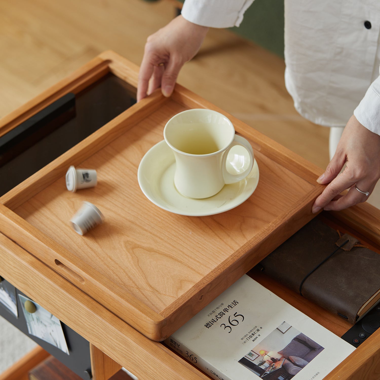 Scandinavian cherry wood wheeled trolley side table pocket in real life style.