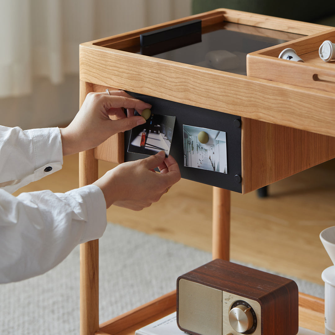 Scandinavian cherry wood wheeled trolley side table pocket in details.