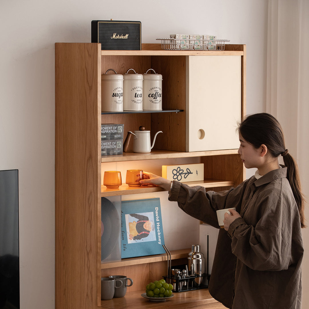 Scandinavian cherry wood storage side cabinet time in close up details.