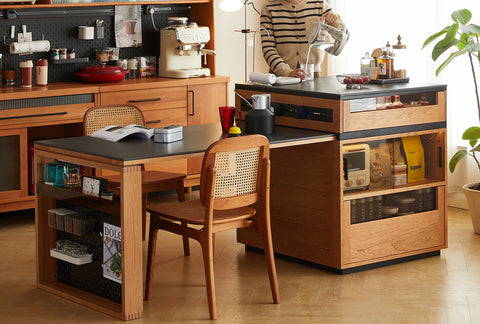 Modern kitchen with a wooden dining table and cabinets, featuring a person preparing a drink. Explore all tables at Loft Home Furniture.