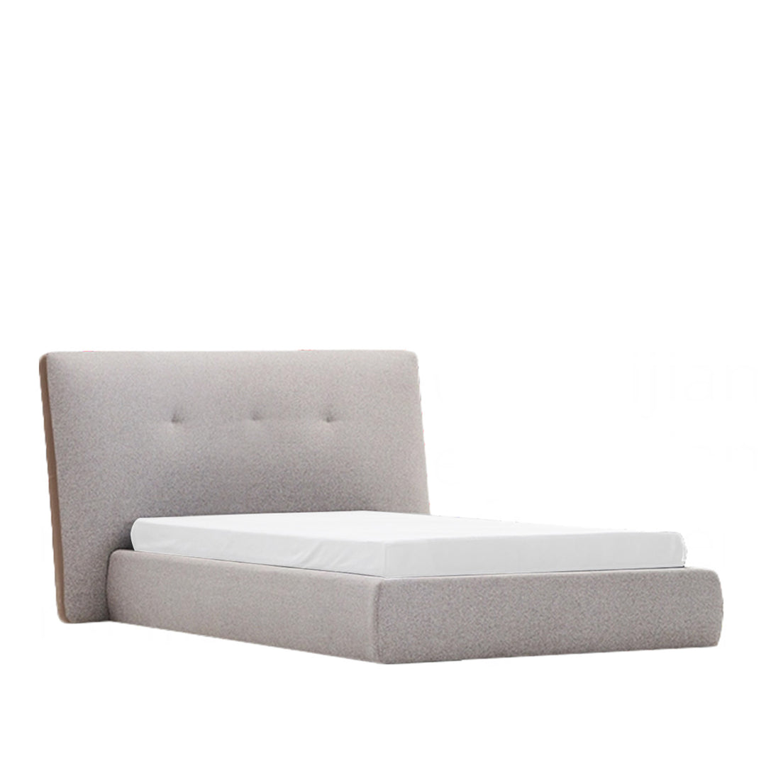 Gray upholstered bed with tufted headboard on a white background