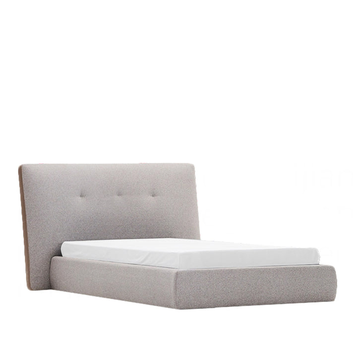 Gray upholstered bed with tufted headboard on a white background