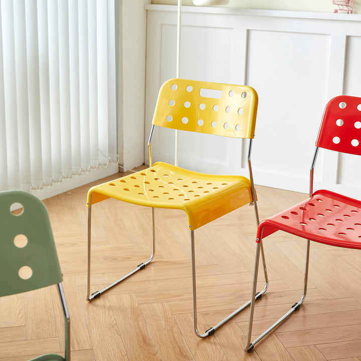 Contemporary plastic dining chair omkstak in panoramic view.