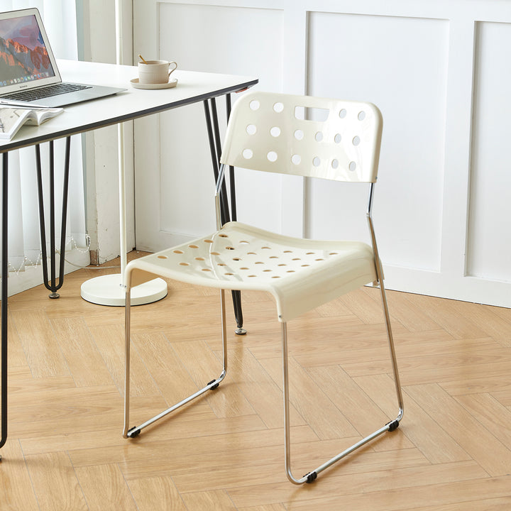 Contemporary plastic dining chair omkstak in still life.