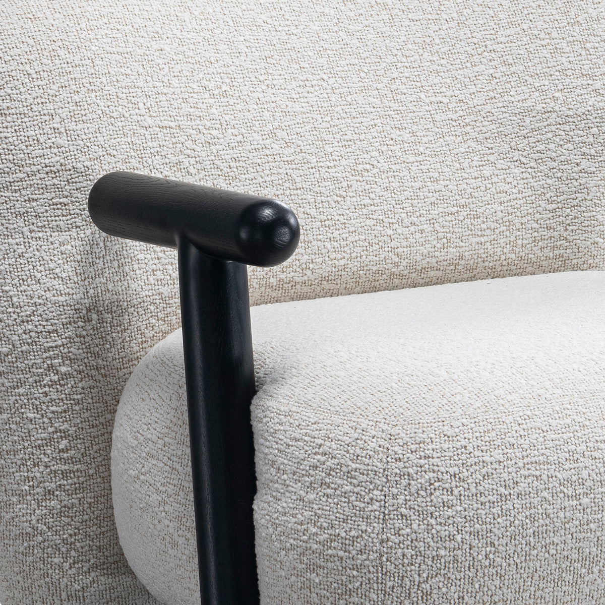 Cream boucle fabric 1 seater sofa with armrest malt with context.