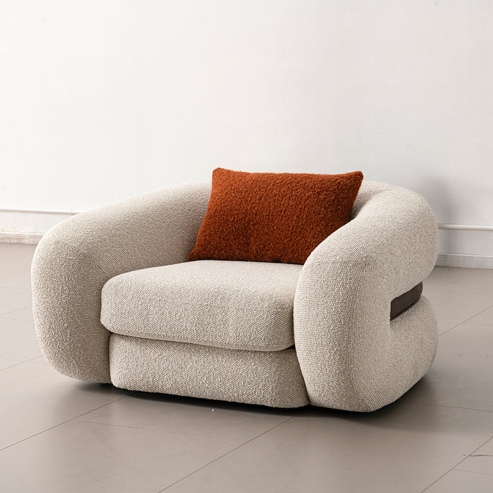 Cream boucle fabric 1 seater sofa curly in close up details.