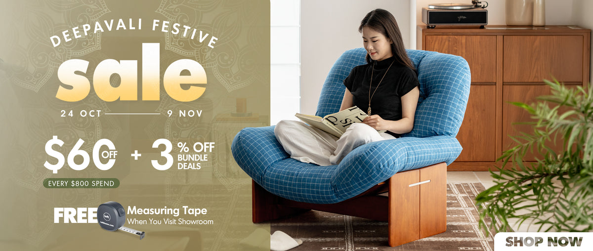A promotional banner for a Deepavali Festive sale, featuring a woman sitting in a blue plaid armchair reading a book in a cozy room setting. The left side of the banner contains sale details in text, including '$60 off + 3% off bundle deals' and 'Free Measuring Tape When You Visit Showroom'.