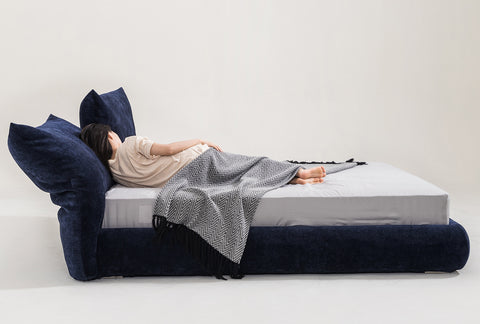 Comfortable fabric bed frame with a navy blue upholstered headboard and cozy bedding, perfect for modern bedroom interiors, linking to Loft Home's fabric bed frame collection.