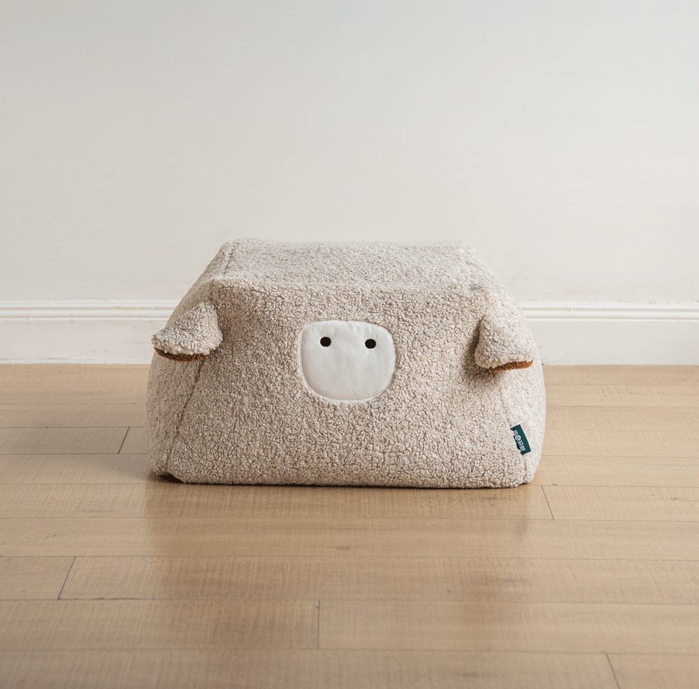 Cream boucle fabric ottoman sheep color swatches.