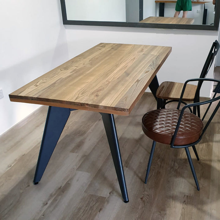 Industrial elm wood dining table ran in panoramic view.