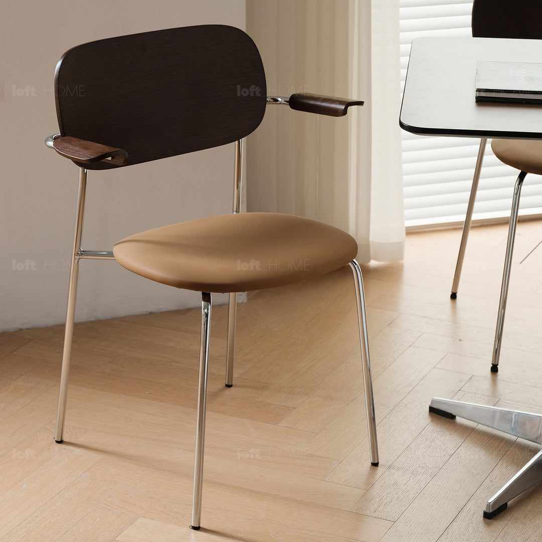 Industrial pu leather dining chair with armrest nika in still life.