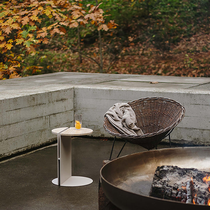 Industrial travertine stone metal side table liska with context.