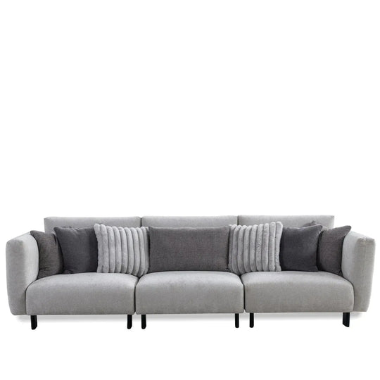 Modern boucle fabric bendable armrest 4 seater sofa pristine in white background.