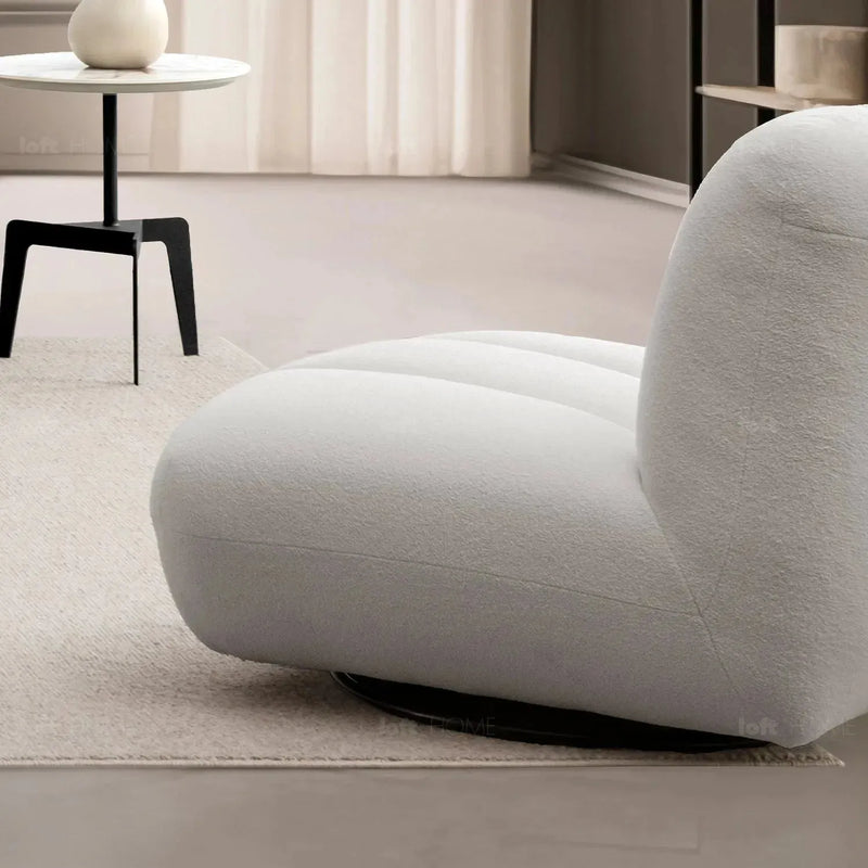 Cream sherpa fabric revolving 1 seater sofa limestone in panoramic view.