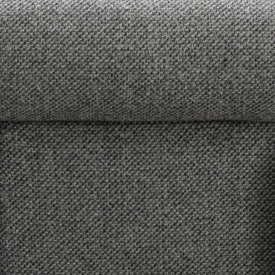 Minimalist fabric 1 seater sofa monolithe in close up details.