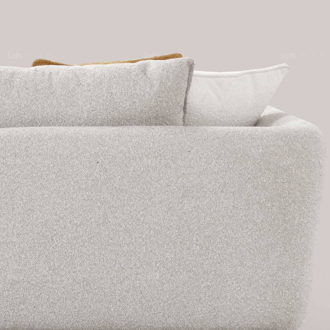 Minimalist fabric 3 seater sofa angler in close up details.