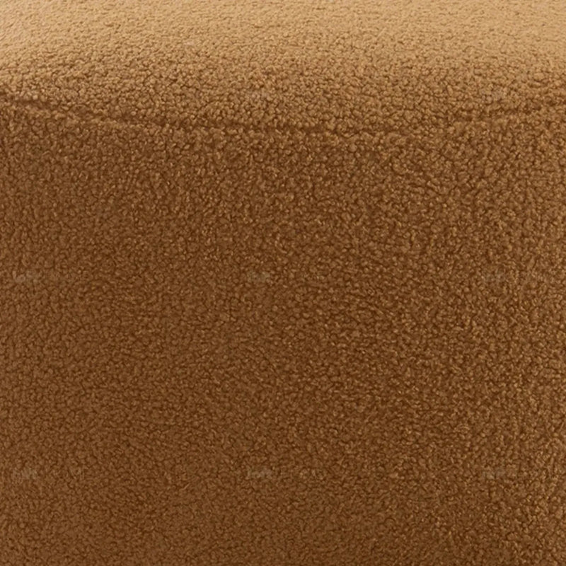Cream sherpa fabric ottoman saffron in panoramic view.