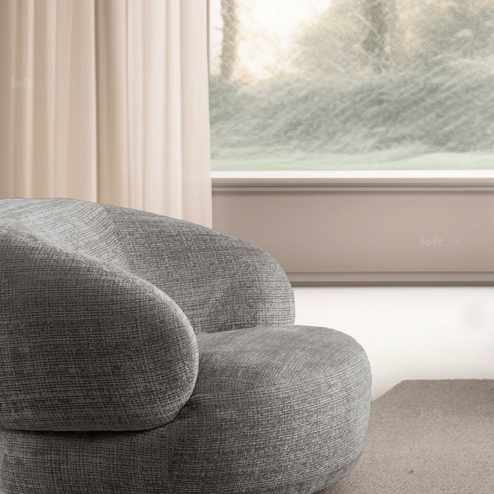 Minimalist fabric revolving 1 seater sofa criet in close up details.