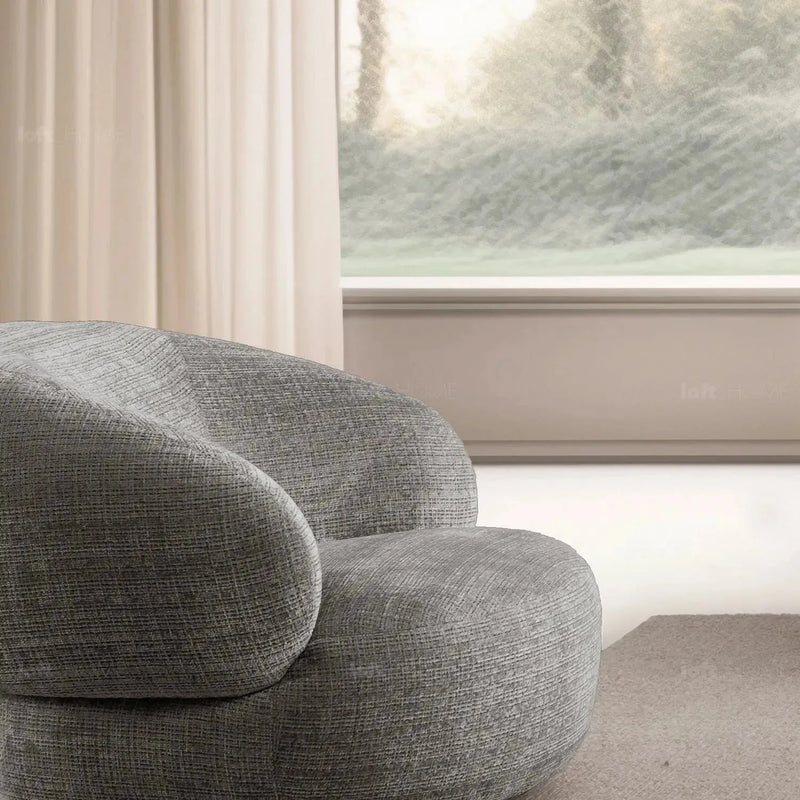 Cream mixed weave fabric revolving 1 seater sofa criet in close up details.