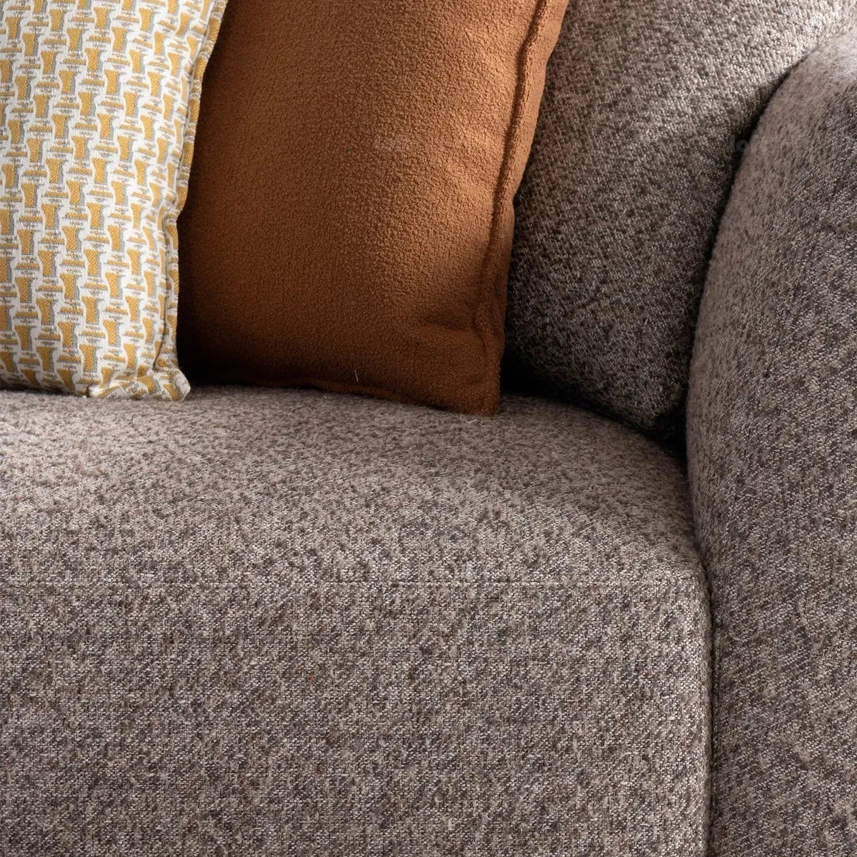 Minimalist mixed weave fabric 4 seater sofa glider in still life.