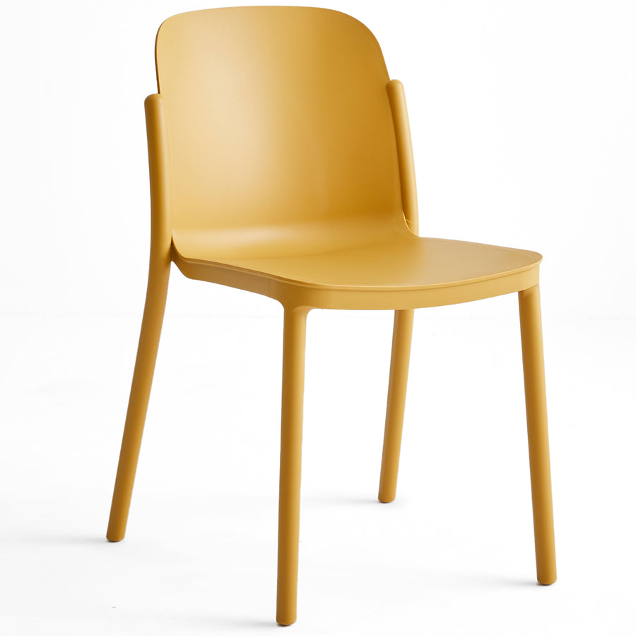 Contemporary plastic stackable dining chair glint in white background.