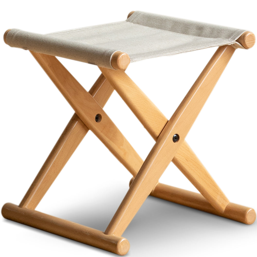 Scandinavian beech wood canvas folding stool kaya in white background.