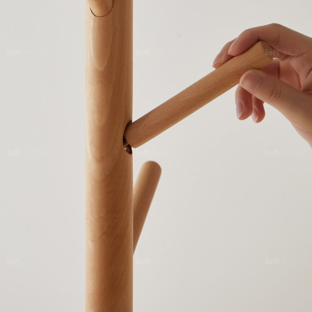 Scandinavian beech wood quartz stone base clothes hanger pebble in close up details.