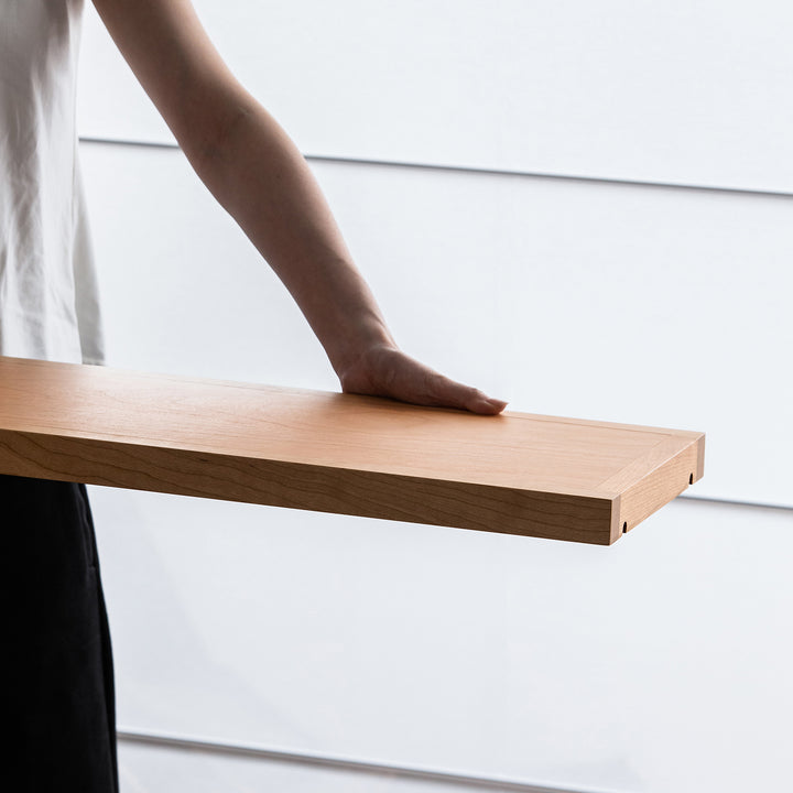 Scandinavian cherry wood bookshelf time in still life.