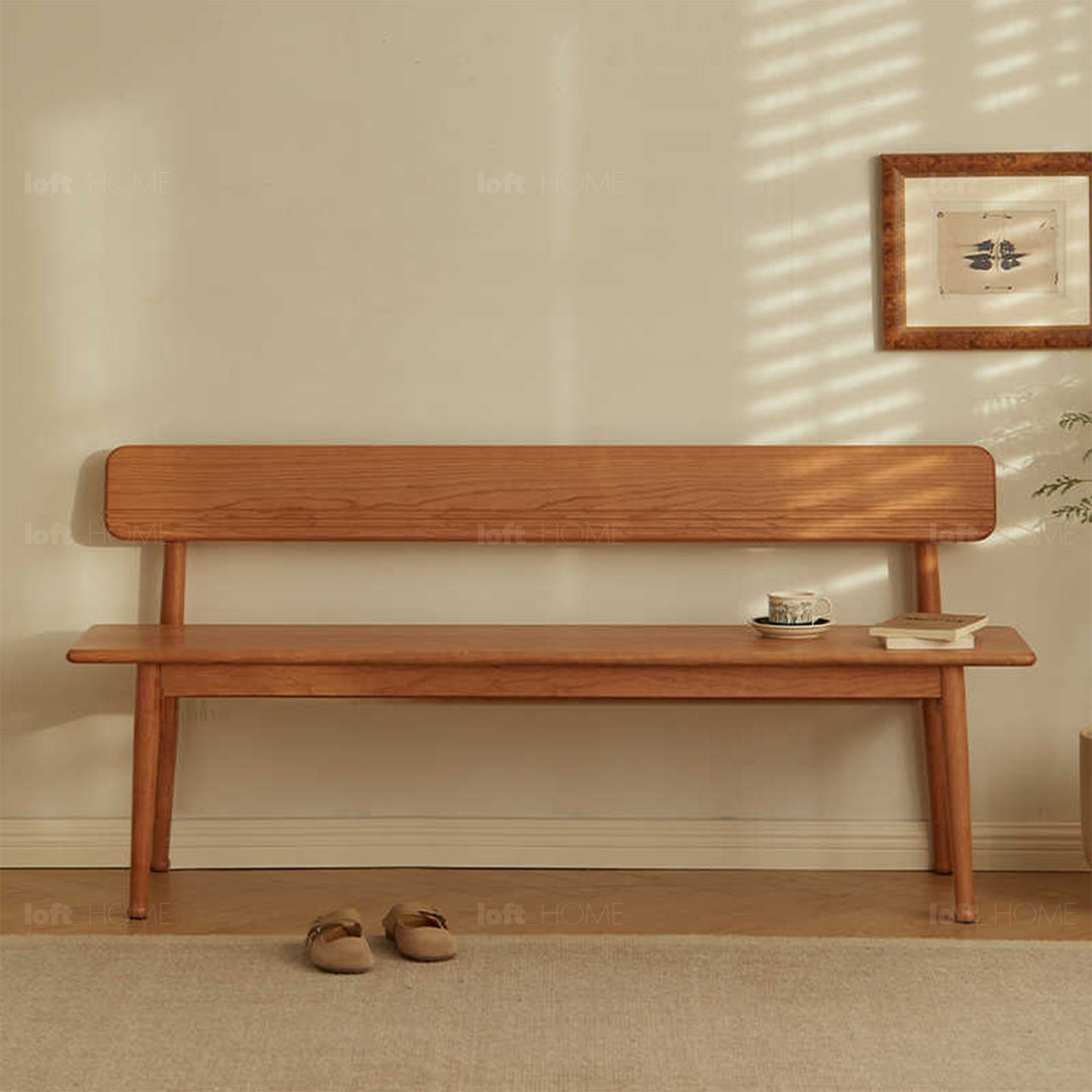 Scandinavian cherry wood cushion bench with backrest serene with context.