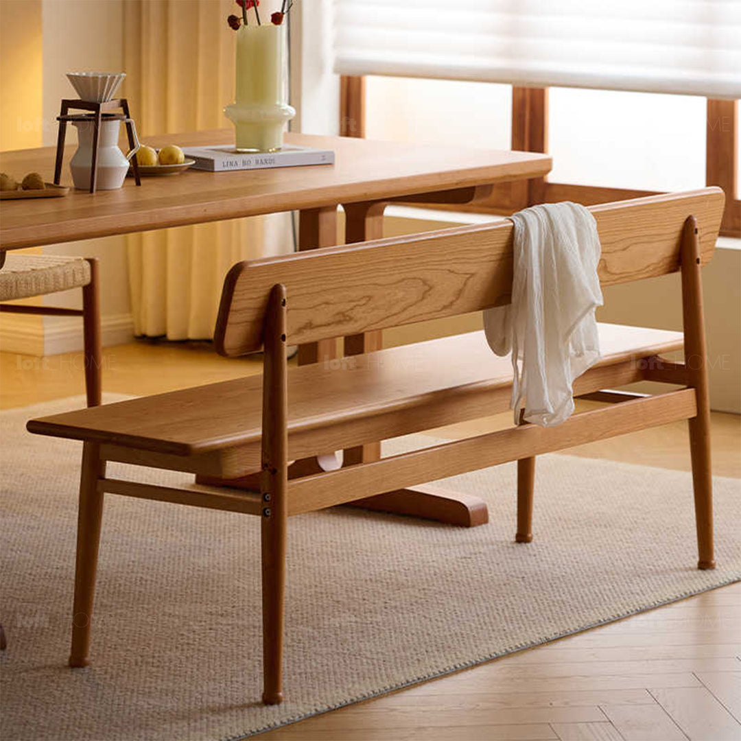 Scandinavian cherry wood cushion bench with backrest serene in details.