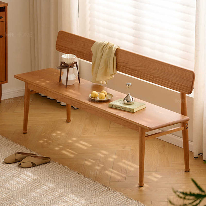 Scandinavian cherry wood cushion bench with backrest serene in close up details.