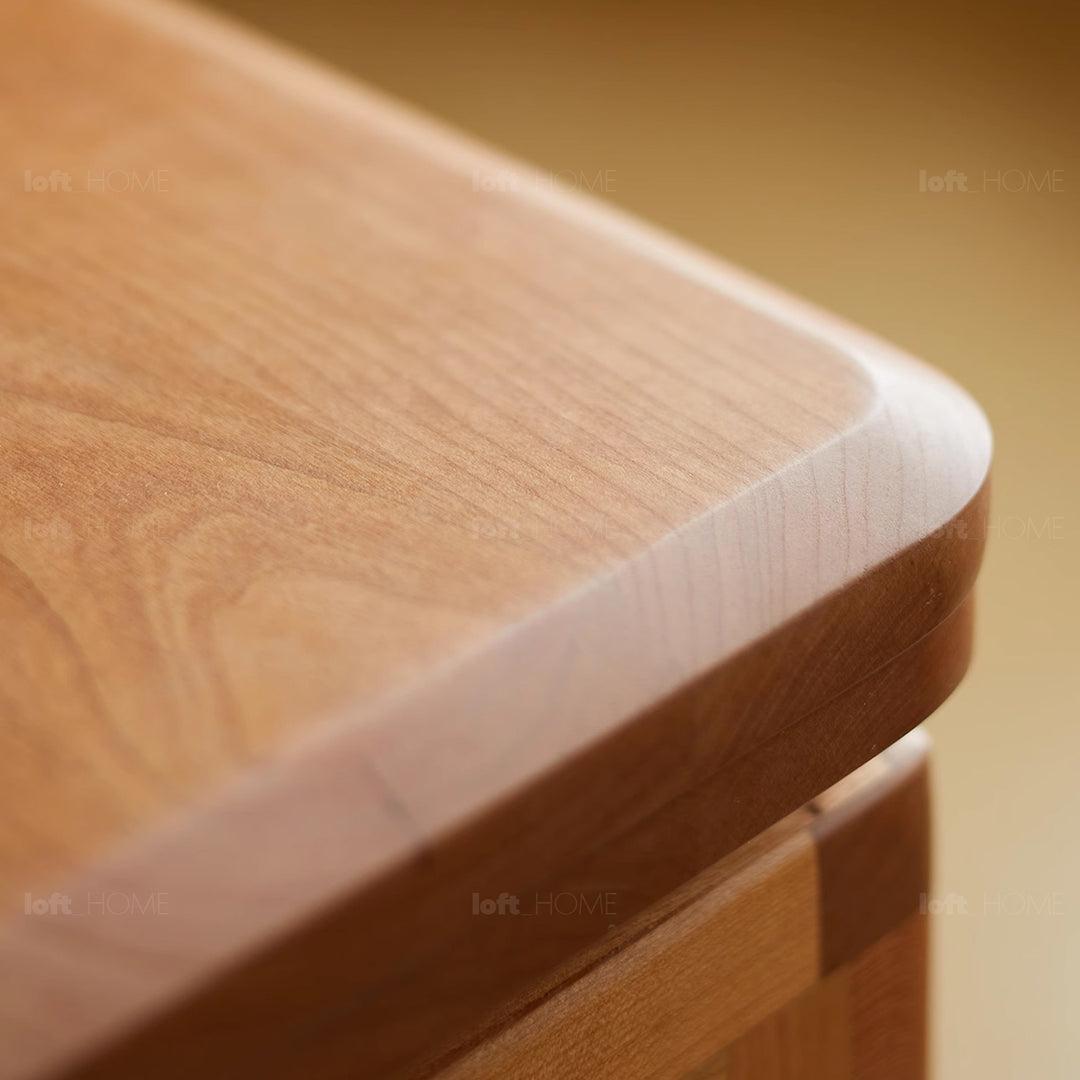 Scandinavian cherry wood extendable coffee table whisroll in close up details.