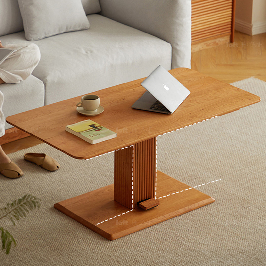 Scandinavian cherry wood height adjustable coffee table elevate in close up details.