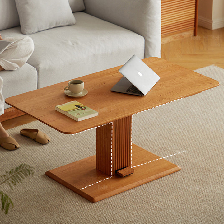 Scandinavian cherry wood height adjustable coffee table elevate in close up details.