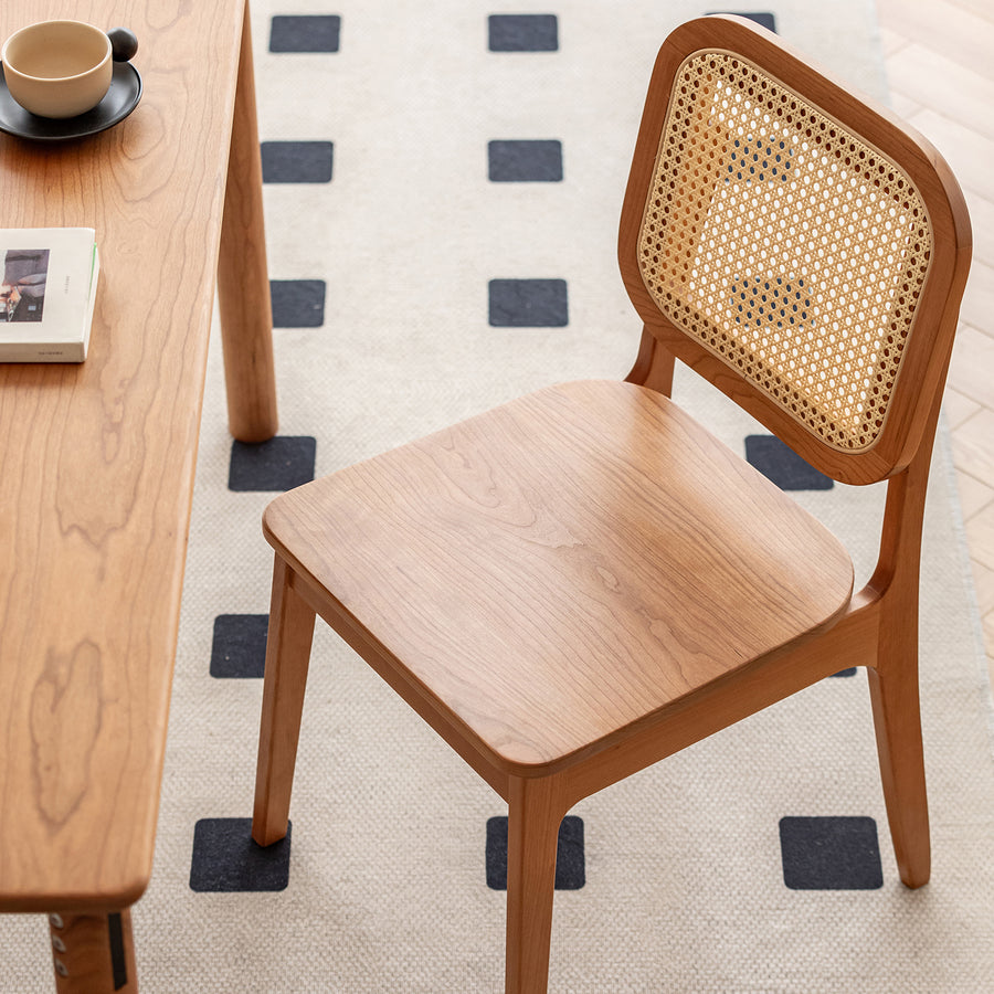Scandinavian cherry wood rattan dining chair nook primary product view.