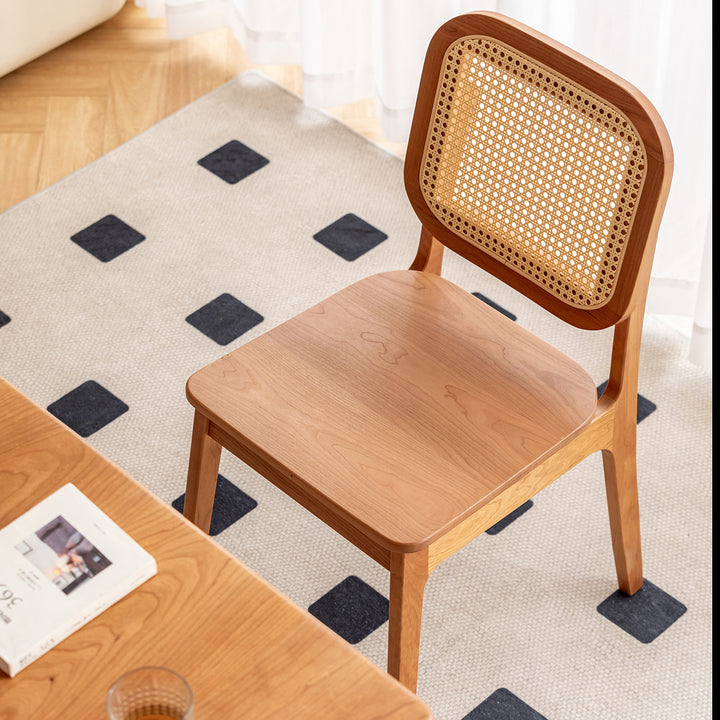 Scandinavian cherry wood rattan dining chair nook in real life style.