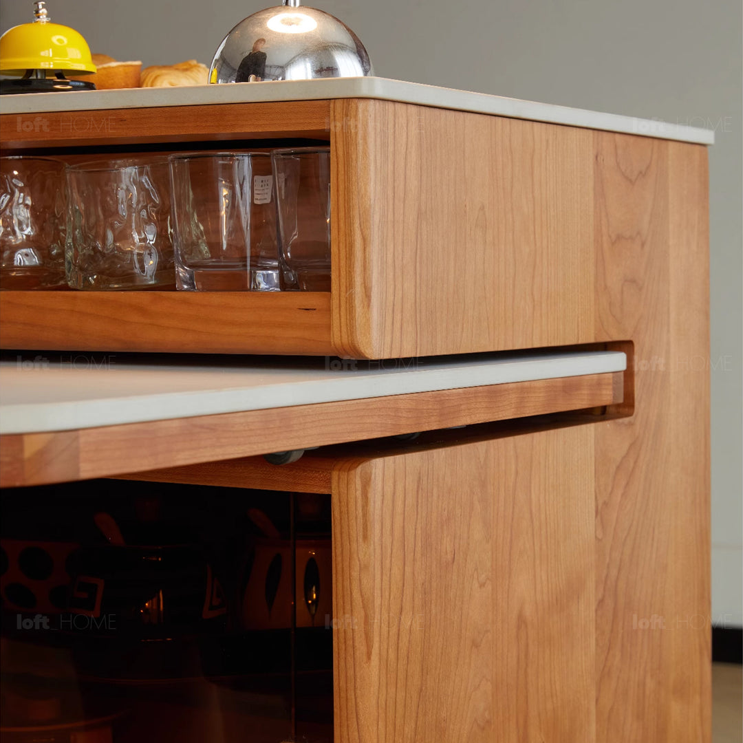 Scandinavian cherry wood sintered stone extendable island dining table with cabinet moonlight in close up details.