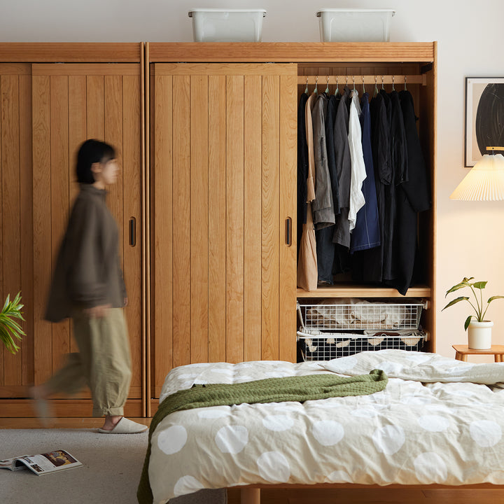 Scandinavian cherry wood sliding door wardrobe nava in close up details.
