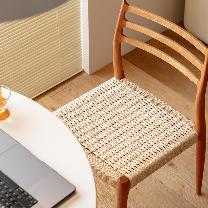 Scandinavian cherry wood woven rope dining chair autumn in real life style.