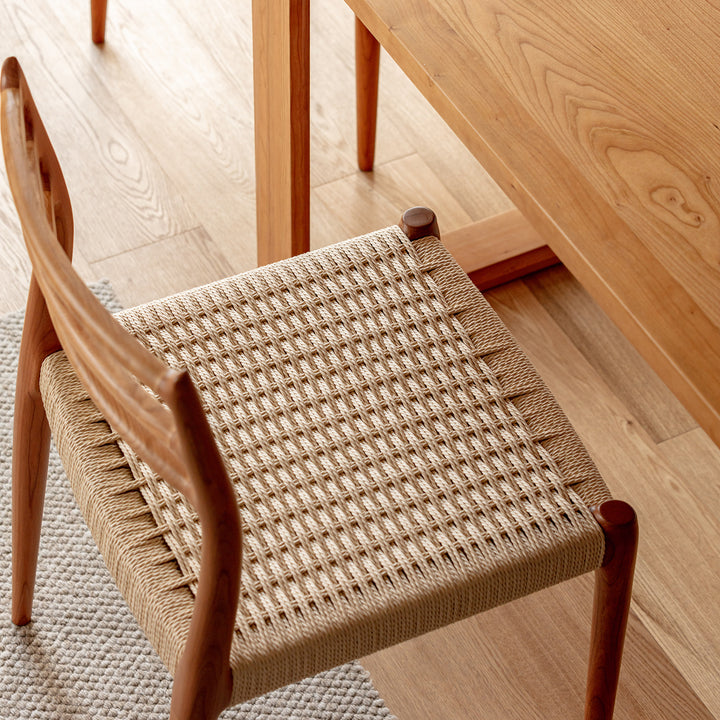 Scandinavian cherry wood woven rope dining chair autumn with context.