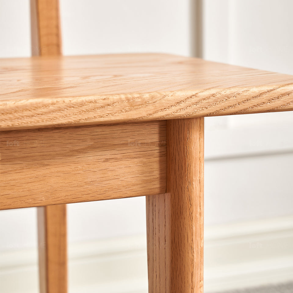 Scandinavian oak wood dining bench with backrest restly in still life.