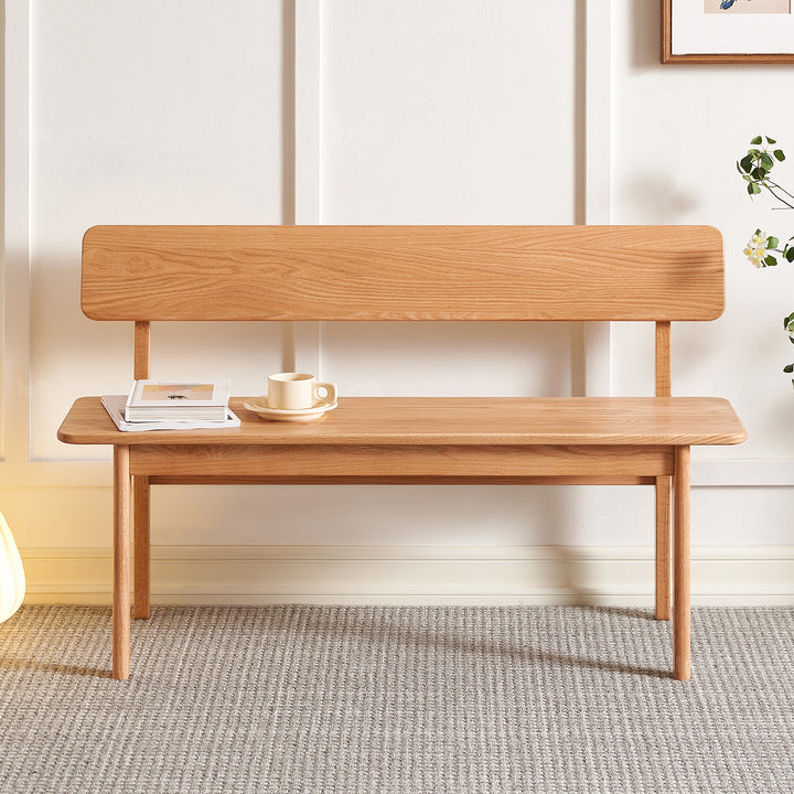 Scandinavian oak wood bench with backrest restly in real life style.