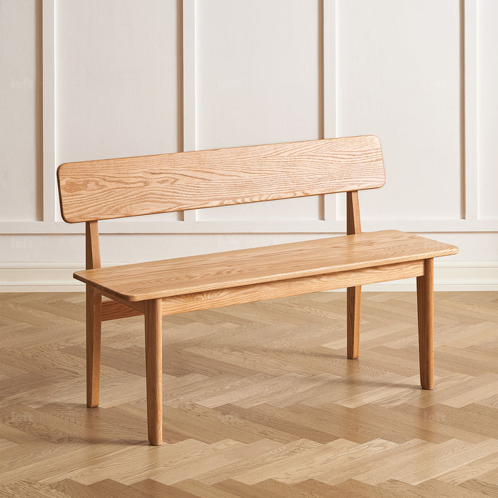 Scandinavian oak wood bench with backrest restly with context.