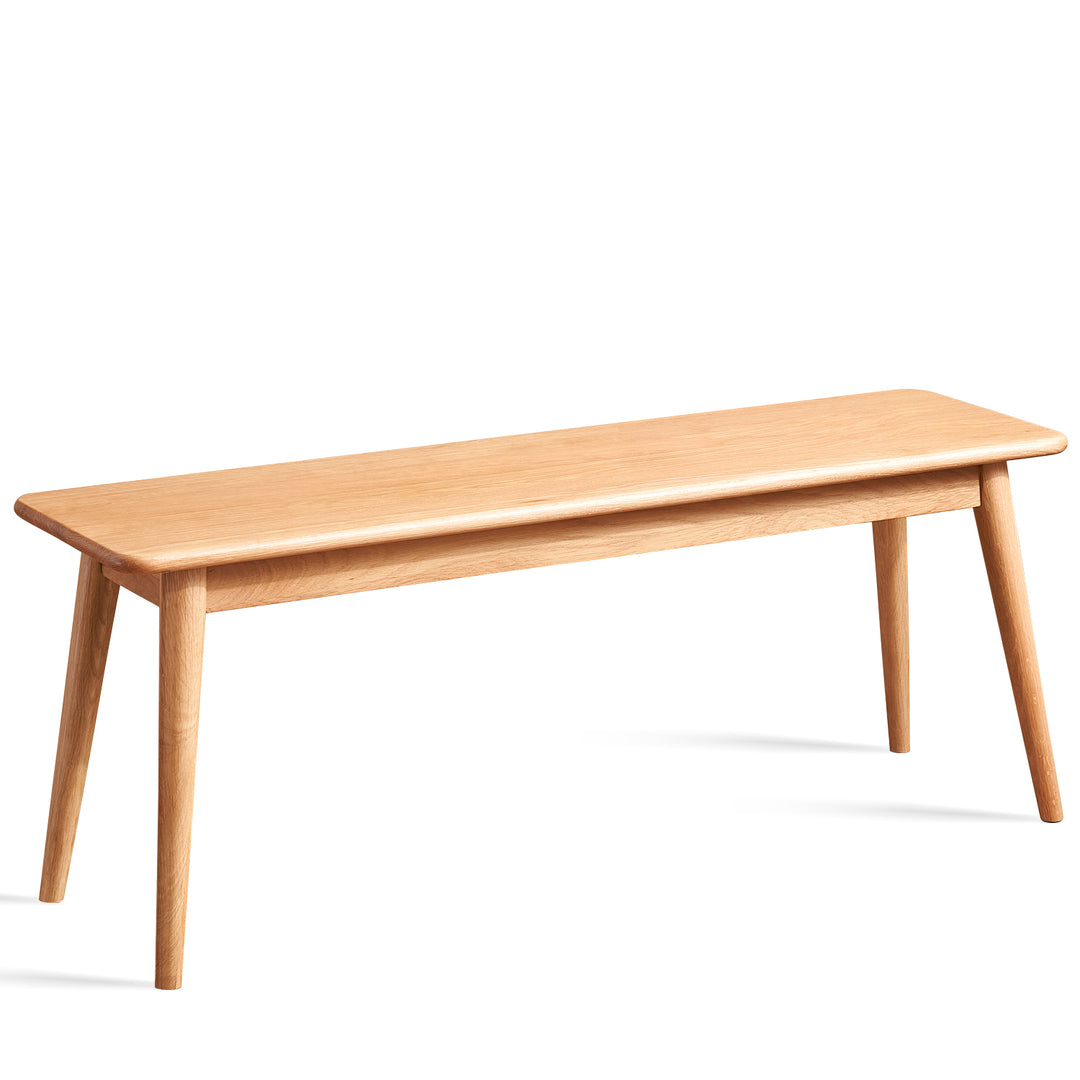 Scandinavian oak wood bench with cushion sereno in white background.